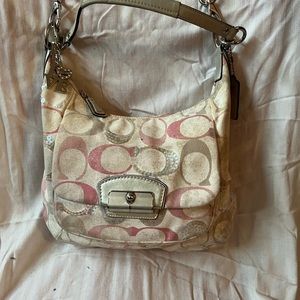 Coach distressed look hobo bag with pink sequin logos and metallic straps